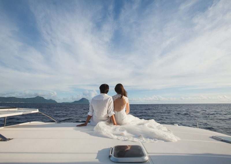 Wedding couple is hugging on a yacht. Beauty bride with groom.